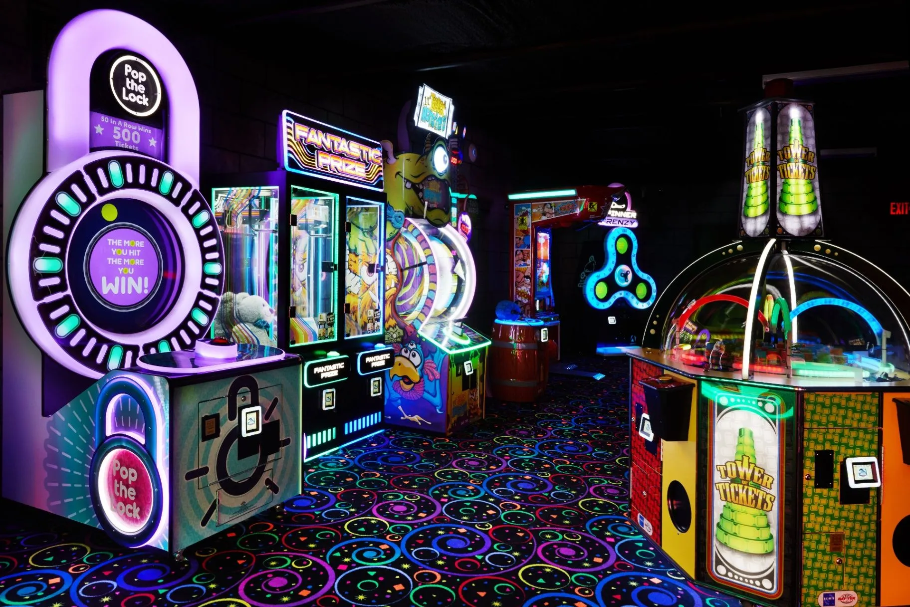 Colorful arcade machines glowing at Cooper’s Kingdom