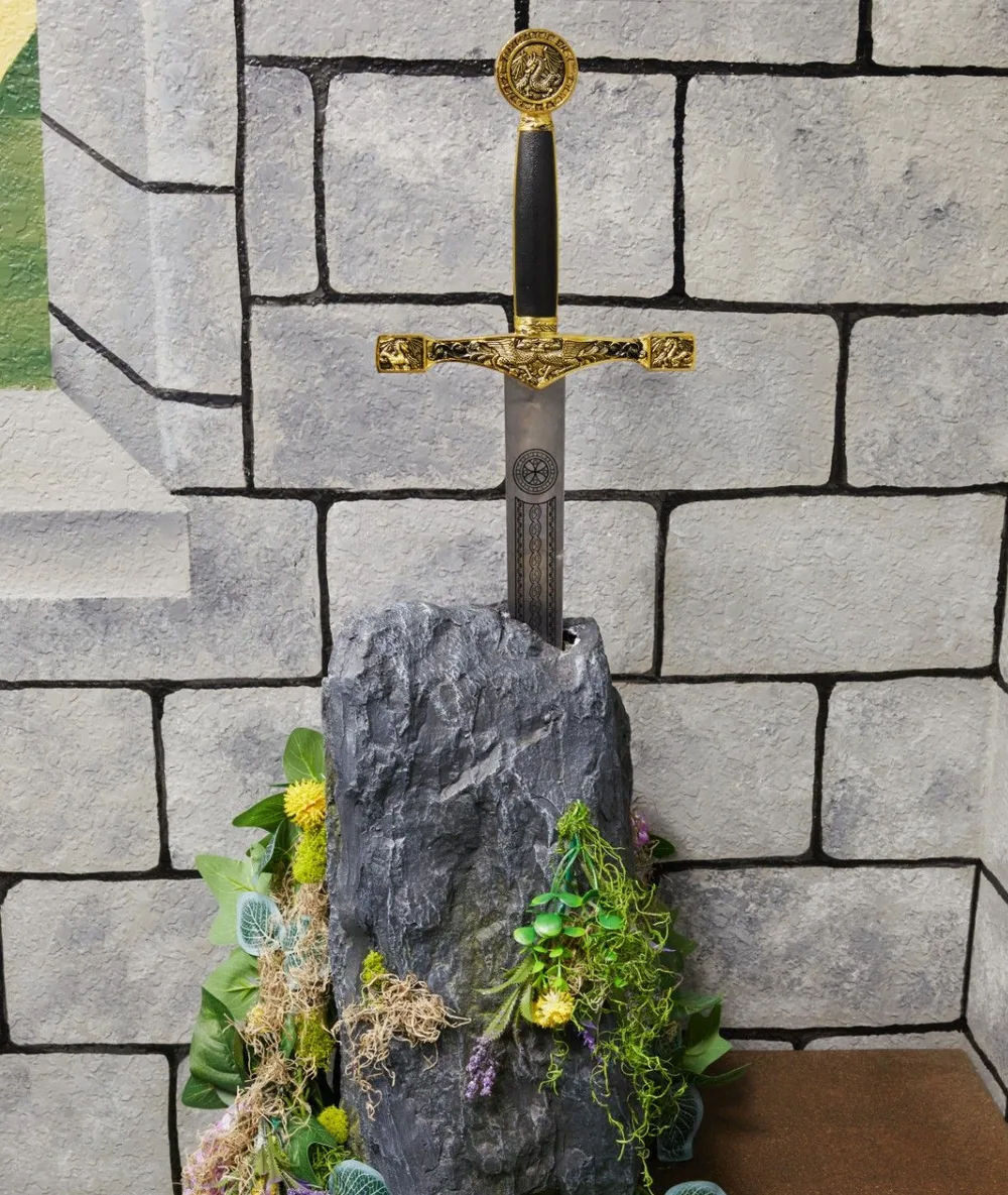 The real full-size Excalibur sword set into its stone in the party room
